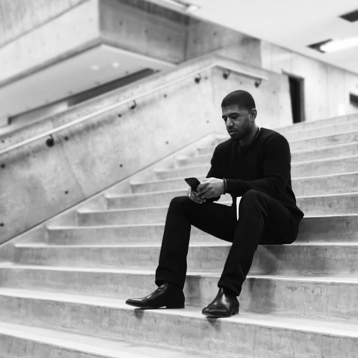 Pablo Milandu sitting on stone steps